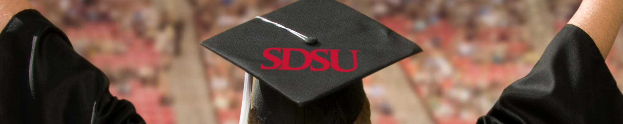 A student wearing a CAP with SDSU letters on