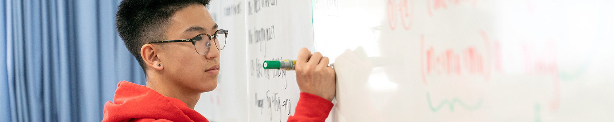 student writing on white board